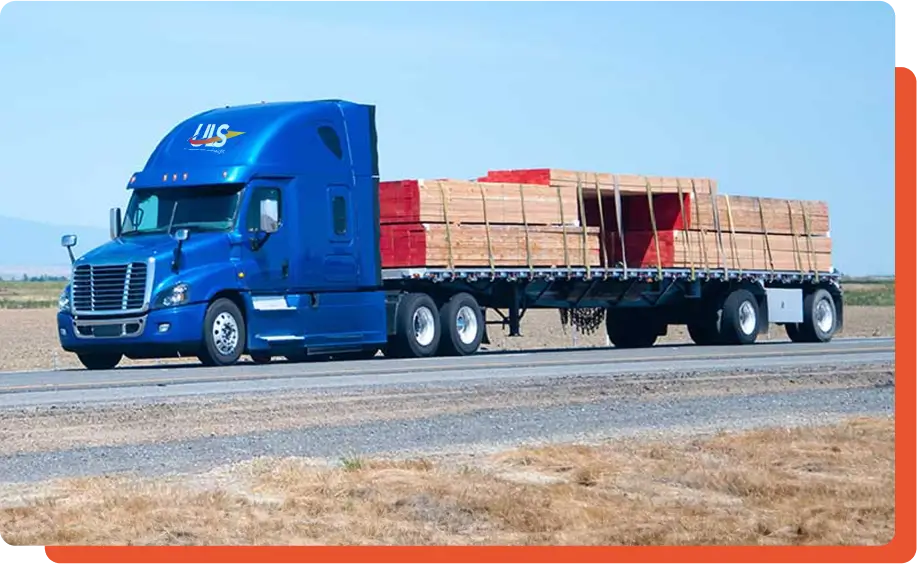 Flatbed truck transporting heavy cargo on highway